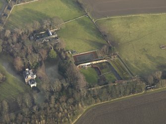 Oblique aerial view centred on the farmhouse with the walled garden and coach house adjacent, taken from the WSW.
