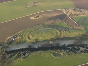 Oblique aerial view centred on the remains of the fort with the farmstead adjacent, taken from the S.