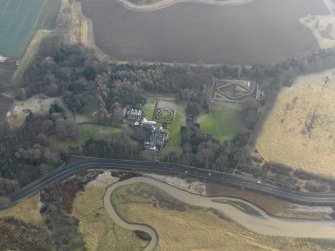 Oblique aerial view centred on the country house with the gardens adjacent, taken from the N.