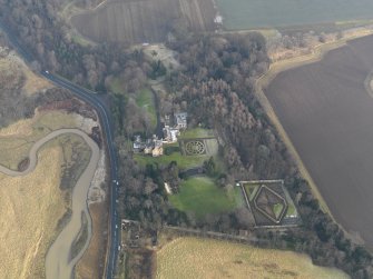 Oblique aerial view centred on the country house with the gardens adjacent, taken from the W.