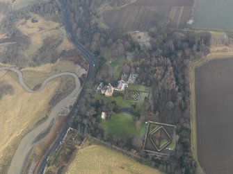 Oblique aerial view centred on the country house with the gardens adjacent, taken from the WSW.