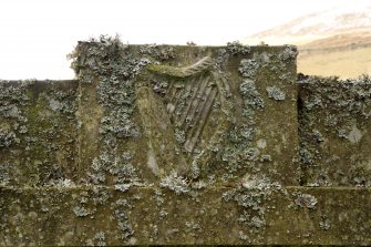 Detail of harp carving to centre of pediment on James Hogg's gravestone in the churchyard of the Parish Church of Ettrick and Buccleuch.