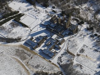Oblique aerial view centred on the derelict hospital, taken from the WNW.