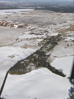 General oblique aerial view of the village and the shale oil works bings, taken from the S.