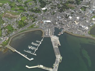 Oblique aerial view centred on the harbour with the town adjacent, taken from the NNW.