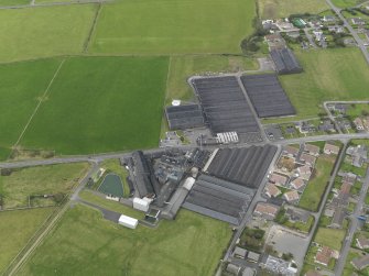 Oblique aerial view centred on the distillery, taken from the SE.
