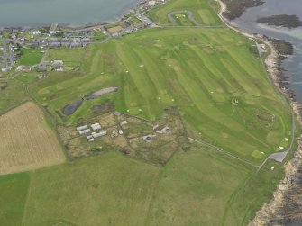 Oblique aerial view centred on the coastal batteries, taken from the WSW.