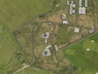 Oblique aerial view centred on the coastal battery, taken from the SE.