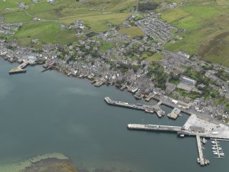 Oblique aerial view centred on the town with the ferry terminal and pier adjacent, taken from the NE.