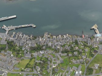 Oblique aerial view centred on the town with the ferry terminal and pier adjacent, taken from the WNW.