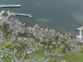 Oblique aerial view centred on the town with the ferry terminal and pier adjacent, taken from the W.