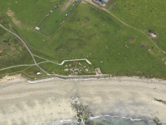Oblique aerial view centred on the prehistoric settlement, taken from the N.