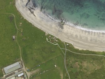 Oblique aerial view centred on the prehistoric settlement, taken from the SE.