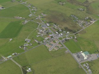 Oblique aerial view centred on the village, taken from the S.