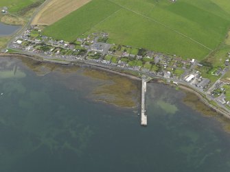 Oblique aerial view centred on the village with the pier adjacent, taken from the SSE.