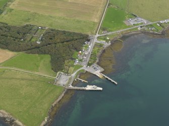 General oblique aerial view centred on the viallge with the harbour adjacents, taken from the S.