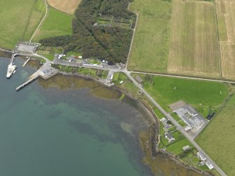 Oblique aerial view centred on the village with the harbour adjacent, taken from the NE.