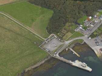 Oblique aerial view centred on the gate house with the harbour adjacent, taken from the SE.