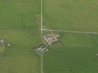 Oblique aerial view centred on the farmhouse with the farmstead adjacent, taken from the NNE.