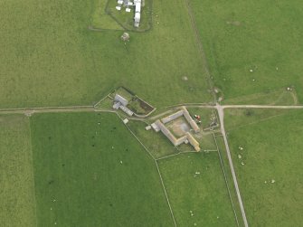 Oblique aerial view centred on the farmhouse with the farmstead adjacent, taken from the NW.