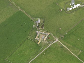 Oblique aerial view centred on the farmhouse with the farmstead adjacent, taken from the WSW.