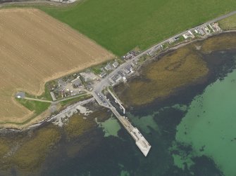 Oblique aerial view centred on the village with the ferry pier adjacent, taken from the ESE.