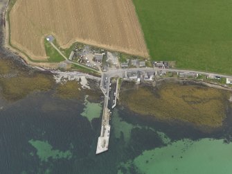 Oblique aerial view centred on the village with the ferry pier adjacent, taken from the E.