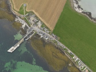 Oblique aerial view centred on the village with the ferry pier adjacent, taken from the NE.