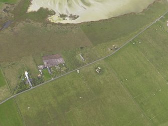 Oblique aerial view centred on the remains of the radar station remote reserve with farmsteads adjacent, taken from the NW.