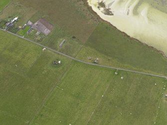 Oblique aerial view centred on the remains of the radar station remote reserve with farmsteads adjacent, taken from the NE.