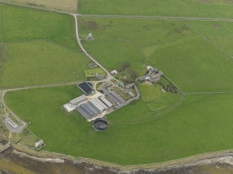 Oblique aerial view centred on the warehouse with the pier adjacent, taken from the SE.