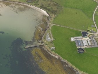 Oblique aerial view centred on the warehouse with the pier adjacent, taken from the E.