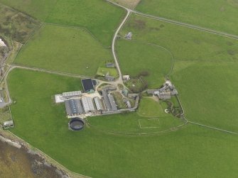 Oblique aerial view centred on the farmhouse, taken from the ESE.