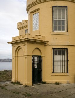 Detail of the lower part of the tower, the entrance and the commemorative plaque from the SSE.