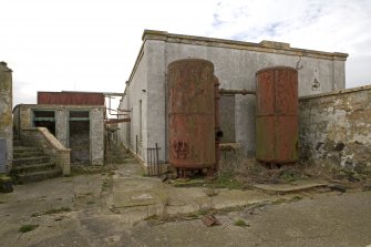 View of N end of lighthouse keepers cottage with twin hot water tanks from NNE.