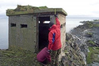 View of blockhouse from NNW and RCAHMS at work.