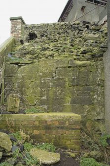 Detail of a section of possible 16th century wall showing rubble infill and facing blocks with 20th century brick platform, taken from SW.