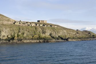 General view from offshore of the barracks/village with 'B' group gun emplacement in the background from NW.