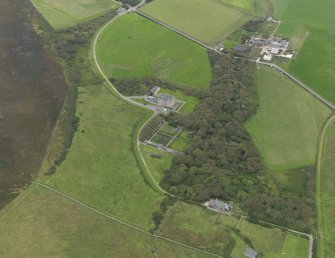 Oblique aerial view centred on the house and gardens, taken from the NW.