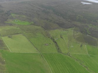 General oblique aerial view of the remains of the farmsteads and fields at Castlehill on Rousay, taken from the NNW.