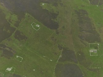 Oblique aerial view centred on the remains of the farmsteads, field systems and head dykes, taken from the NW.