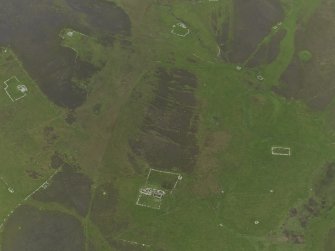 Oblique aerial view centred on the remains of the farmsteads, field systems and head dykes, taken from the WNW.