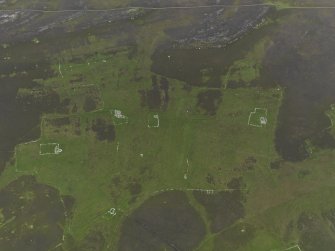 Oblique aerial view centred on the remains of the farmsteads, field systems and head dykes, taken from the NW.