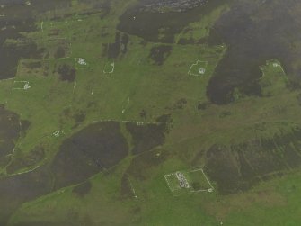 Oblique aerial view centred on the remains of the farmsteads, field systems and head dykes, taken from the WSW.