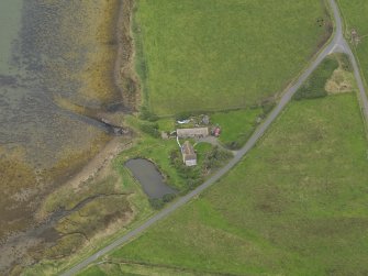 Oblique aerial view centred on the croft house with the slipway adjacent, taken from the SW.