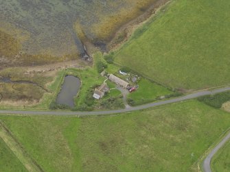 Oblique aerial view centred on the croft house with the slipway adjacent, taken from the SSW.