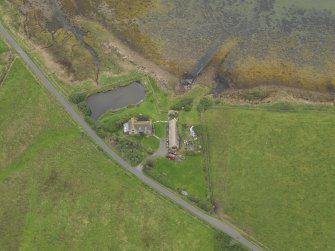Oblique aerial view centred on the croft house with the slipway adjacent, taken from the SE.