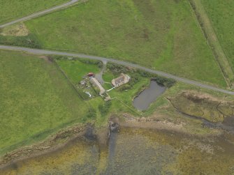 Oblique aerial view centred on the croft house with the slipway adjacent, taken from the NNE.