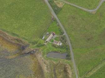 Oblique aerial view centred on the croft house with the slipway adjacent, taken from the WNW.