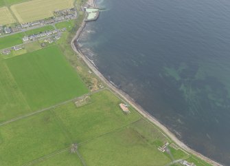 Oblique aerial view centred on the remains of the anti tank blocks with the harbour adjacent, taken from the W.